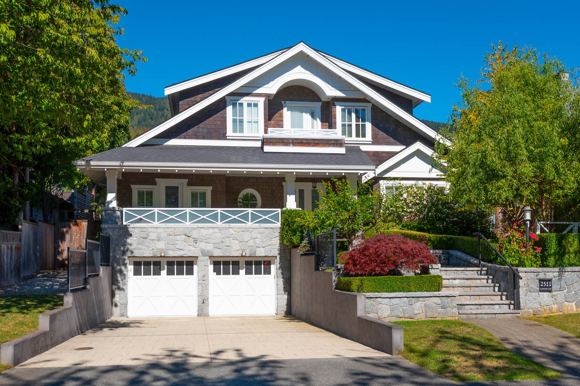 Craftsman-style home with a stone base and double garage